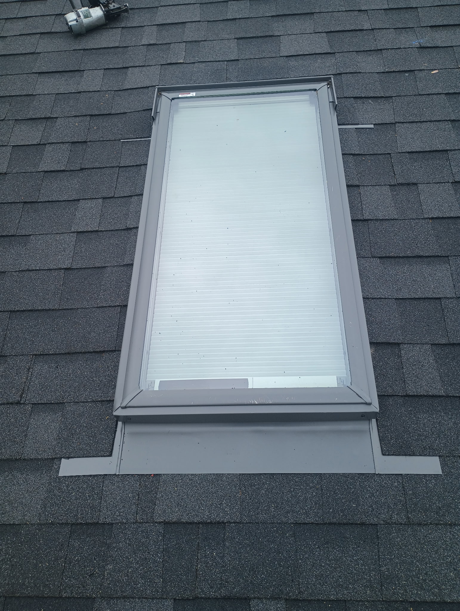 Skylight flashing detail on a completed roof